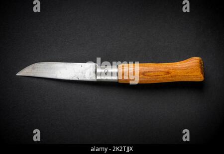 Traditional wooden pocket knife on black background Stock Photo