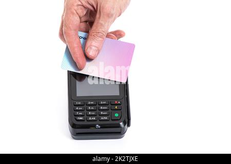 Attached plastic card to the payment terminal with a man's hand on a white isolated background, copy space Stock Photo