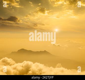Mountains in cloud on sunset Stock Photo