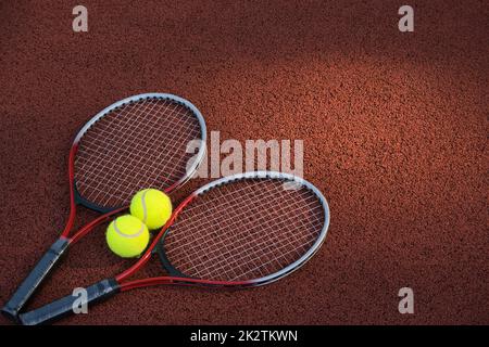 Tennis ball, racquet on hard court surface Stock Photo