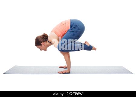 Beautiful sporty fit yogini woman practices yoga asana kakasana Stock Photo