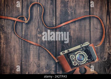 Old retro vintage camera on grunge wooden background Stock Photo