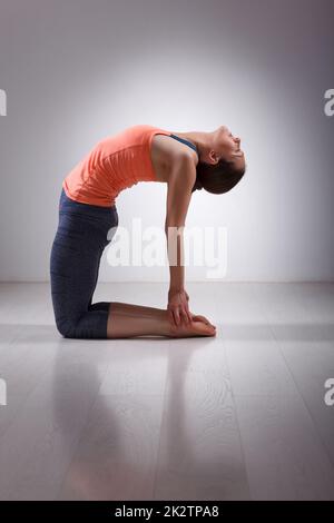 Beautiful sporty fit yogini woman practices yoga asana ustrasana Stock Photo
