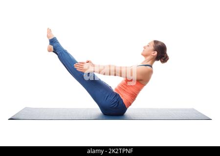 Woman practices yoga asana Paripurna navasana Stock Photo