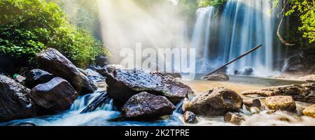 Tropical waterfall in jungle with sun rays Stock Photo