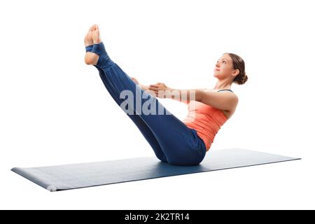 Woman practices yoga asana Paripurna navasana Stock Photo