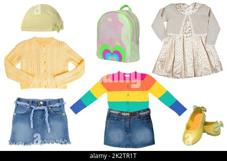 Collage set of little girl summer clothes isolated on a white background. The collection of jeans skirts, sweater, a blouse, dresses, a hood or cap, shoes and bag. Fashionable kids outfit. Stock Photo