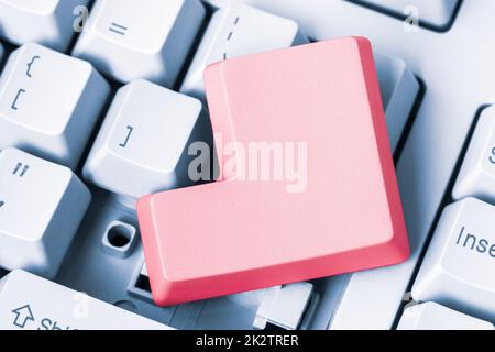 Empty red button removed from computer keyboard Stock Photo