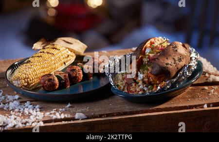 Grilled vegetables and meat balls served on wooden table Stock Photo
