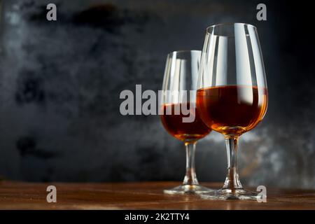 Glasses with sherry wine on table Stock Photo