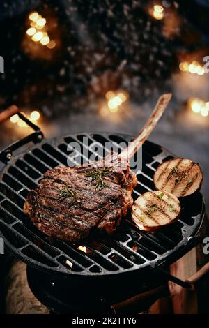 Tomahawk steak preparing on grill Stock Photo