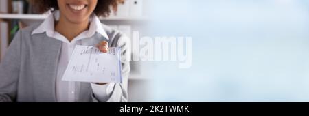 Businessperson Giving Cheque In Office Stock Photo