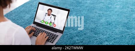Woman Video Conferencing With Doctor On Laptop Stock Photo
