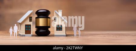 Gavel Between Split Family Figures And House Model Stock Photo