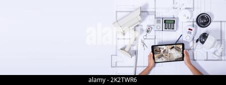 Person Monitoring Smart House On Digital Tablet Stock Photo