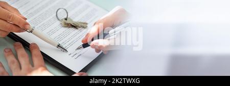 Close-up Of A Person's Hand Filling Contract Form Stock Photo