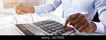 Businessman Calculating Invoice Stock Photo