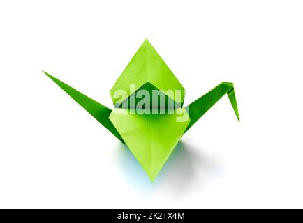 Green paper crane origami isolated on a white background Stock Photo