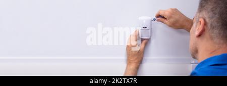 Electrician Installing Security System Door Sensor Stock Photo