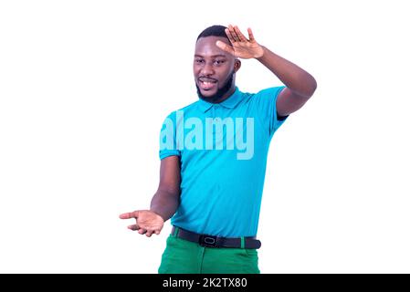 portrait of a handsome young man showing the height of something tall with both hands smiling. Stock Photo