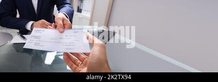 Businessman Giving Cheque Stock Photo