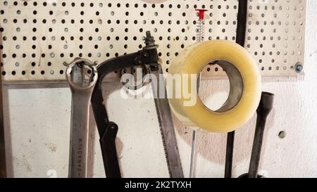 Garage tools hanging on the wall. Stock Photo