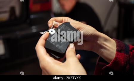 Holding new car brake pads, auto repair concept. Stock Photo