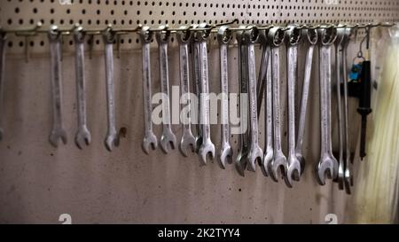Garage tools hanging on the wall. Stock Photo