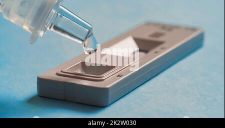 Liquid drops into cassette of Coronavirus Covid-19. Stock Photo