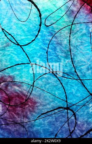 Antique Blue Glass With Black Paint Splashed on surface and Light Shining through back Stock Photo