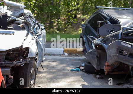 Many broken cars after a traffic accident in the parking lot of a  restoration service station on the street. Car body damage workshop  outdoors. Sale of insurance emergency vehicles at auction. 8280684
