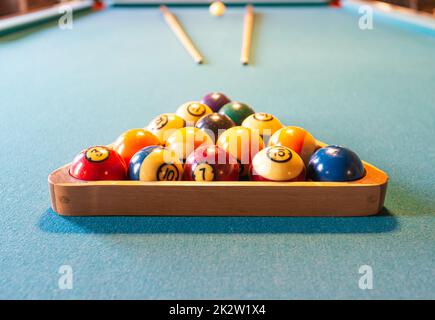 Billiard table with balls and sticks Stock Photo