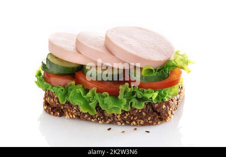 Sandwich with sliced sausage and vegetables isolated on a white background. Stock Photo