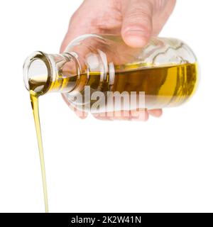 Oil pouring from a bottle. Stock Photo