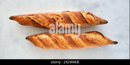 Freshly baked baguette on a light background. Stock Photo