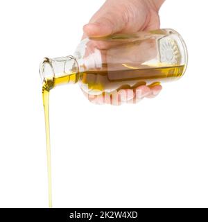 Oil pouring from a bottle. Stock Photo