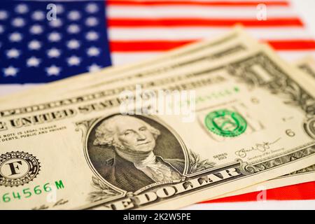 US dollar banknotes money on USA America flag, finance economy concept. Stock Photo