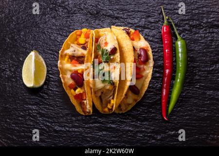 three mexican tacos on slate Stock Photo