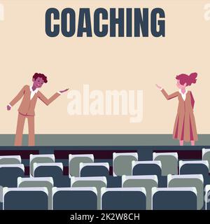 Hand writing sign Coaching. Business idea person supports client in achieving specific personal goal Male and female colleagues doing presentation on stage with hand gestures. Stock Photo
