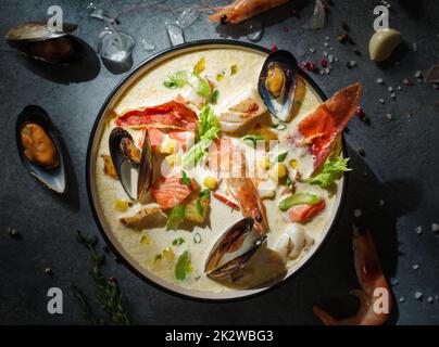 New England clam chowder, occasionally referred to as Boston or Boston-style Clam Chowder. Creamy soup with shrimp, corn, bacon and mussels Stock Photo