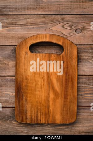 Wooden cutting board, handmade wood cutting board on wooden craft table. Stock Photo