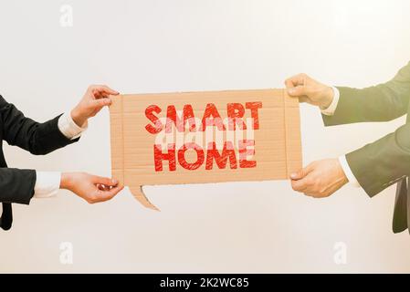 Conceptual caption Smart Home. Business approach automation system control lighting climate entertainment systems Colleagues Sitting On Desk With Laptop Papers Showing Graphs Conversation Stock Photo