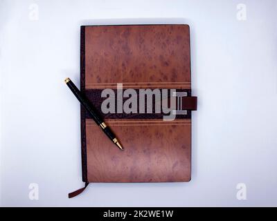 Notepad with ballpoint pen isolated on white background Stock Photo