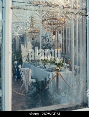 A table set with winter and christmas decor placed in a garden house Stock Photo