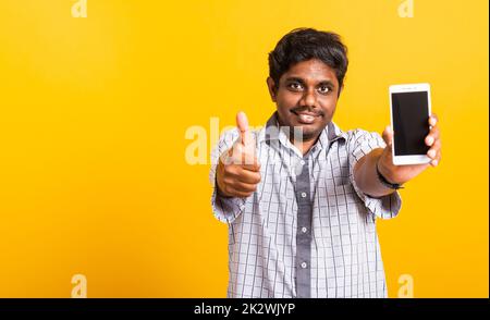 black man smile showing a mobile smartphone blank screen and finger thumb up Stock Photo
