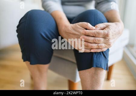 Senior woman holding her painful knee Stock Photo