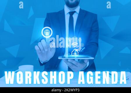 Hand writing sign Workshop Agenda. Word Written on helps you to ensure that your place stays on schedule Man holding Screen Of Mobile Phone Showing The Futuristic Technology. Stock Photo