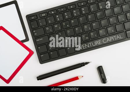 Text sign showing Venture Capital. Internet Concept financing provided by firms to small early stage ones Computer Keyboard And Symbol.Information Medium For Communication. Stock Photo