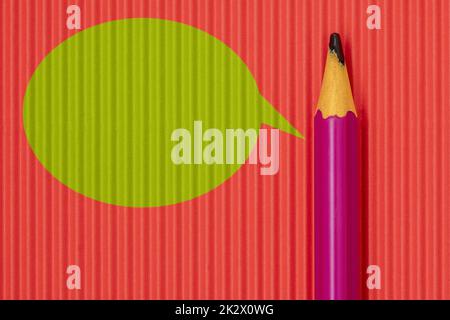 Purple pencil on with green speech bubble Stock Photo