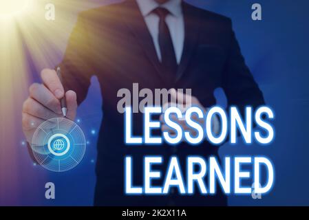 Hand writing sign Lessons Learned. Conceptual photo Promote share and use knowledge derived from experience Man holding Screen Of Mobile Phone Showing The Futuristic Technology. Stock Photo